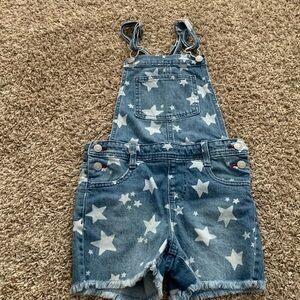The brand for these overalls is target with denim and stars size is medium 7-8
